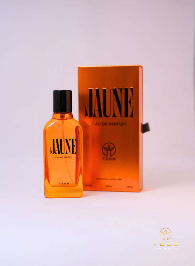 Jaune Eau de Parfum bottle beside its orange box on a soft lilac background