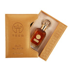 Open gold TEEB Oud Al Amiri gift box showing the bottle inside beside its embossed sleeve