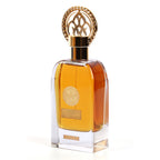 Oud Al Khas bottle with amber liquid and ornate gold cap, seen at an angle